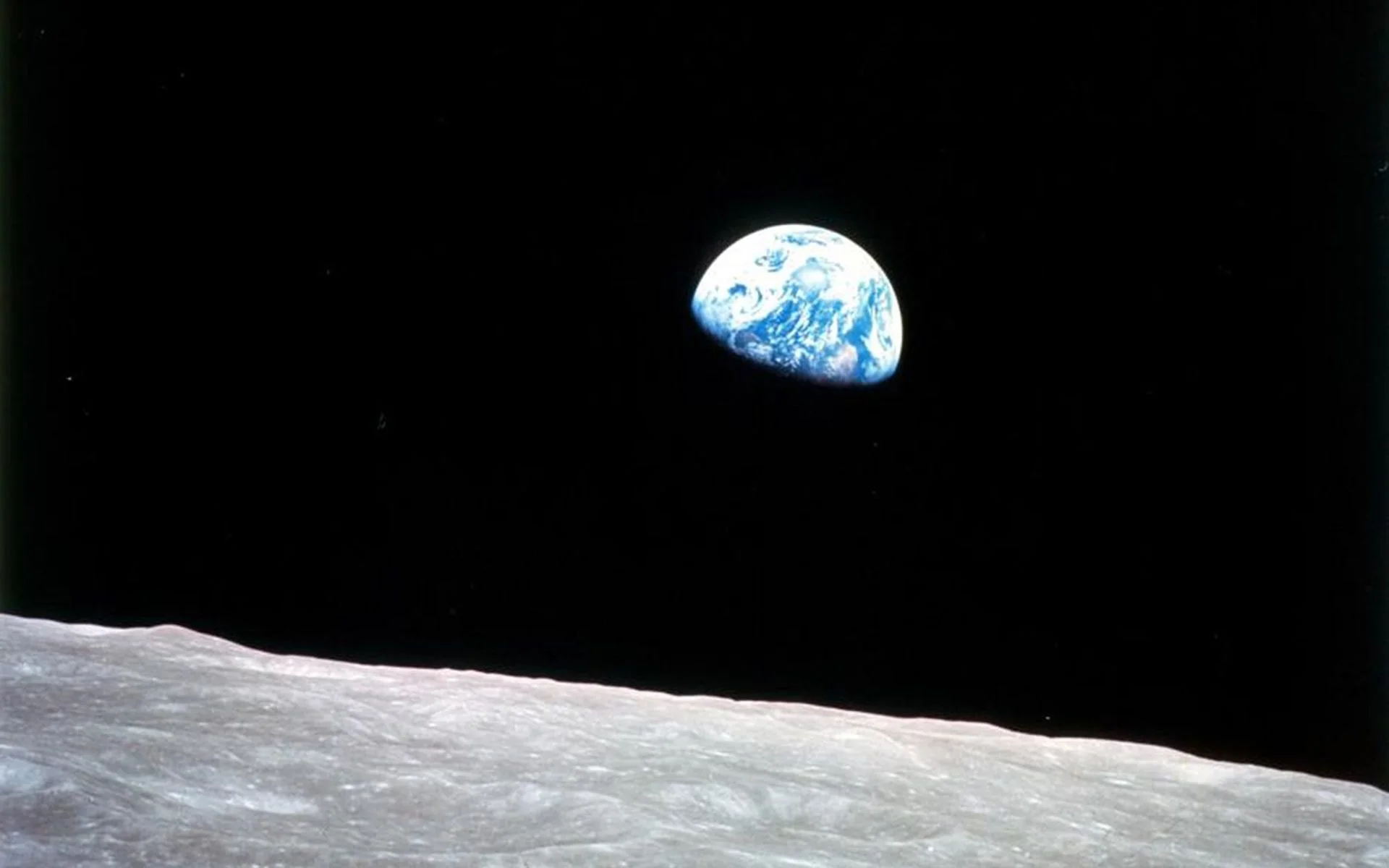 Earth rising above the Moon's horizon as photographed from Apollo 8